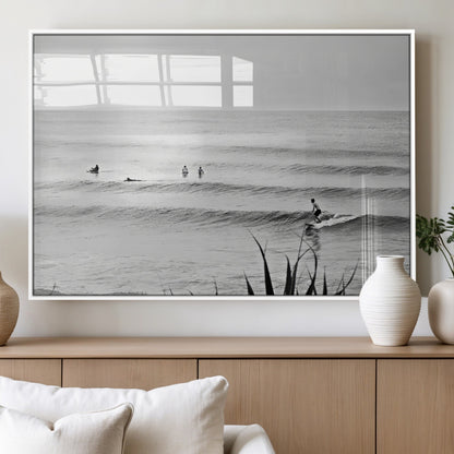 Monochrome canvas of surfers on calm ocean waves, ideal for minimalist coastal or beach-inspired interior decor.