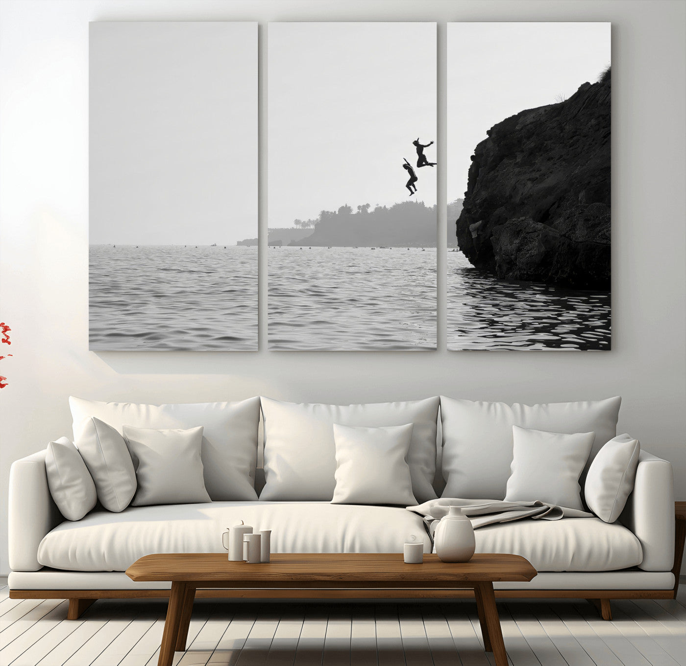 Black and white canvas of two figures cliff jumping into the sea, captured with moody tones, ideal for modern coastal or adventure-themed home decor.   2/2