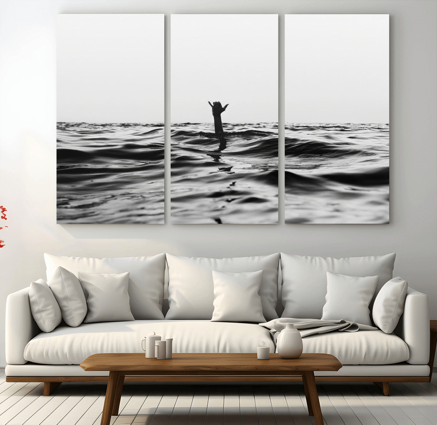 Black and white ocean with a hand making a surfer sign among dark waves, creating a dramatic and minimalist seascape with bold contrast.