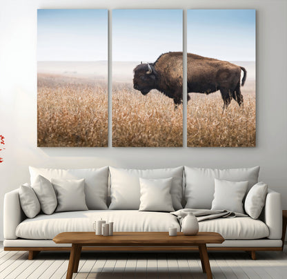A majestic bison standing in an open prairie field, its strong form blending into the golden grass under a vast blue sky, evoking the wild spirit of the American plains.