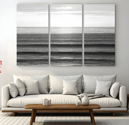 Minimalist black and white ocean view with layered waves reflecting sunlight, evoking a sense of calm and coastal serenity.