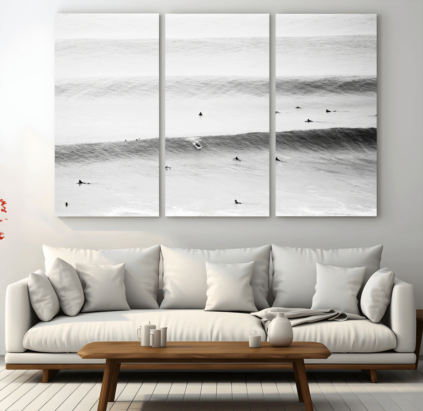 A monochrome photograph of swimmers gliding through gentle ocean waves, evoking a sense of calm and movement.