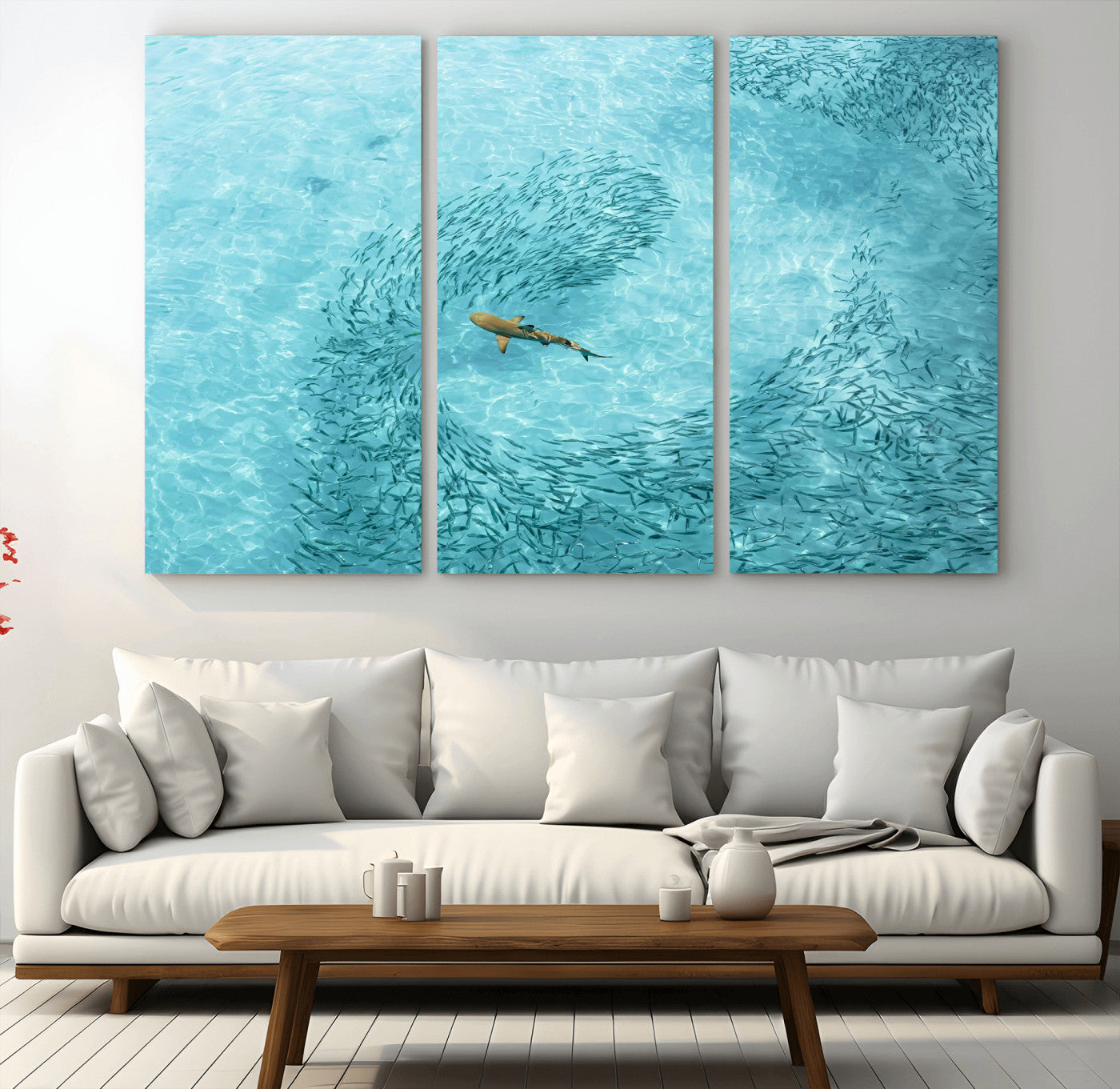 Aerial view of a shark swimming through a swirl of fish in clear turquoise waters, perfect for calm coastal or beach house decor.