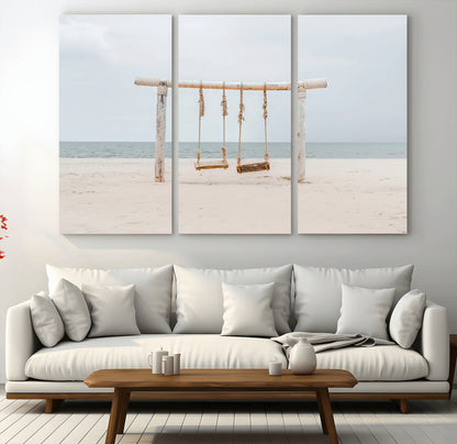A rustic wooden beach swing stands on a serene sandy shore with an ocean horizon in the background, creating a tranquil and dreamy coastal escape.