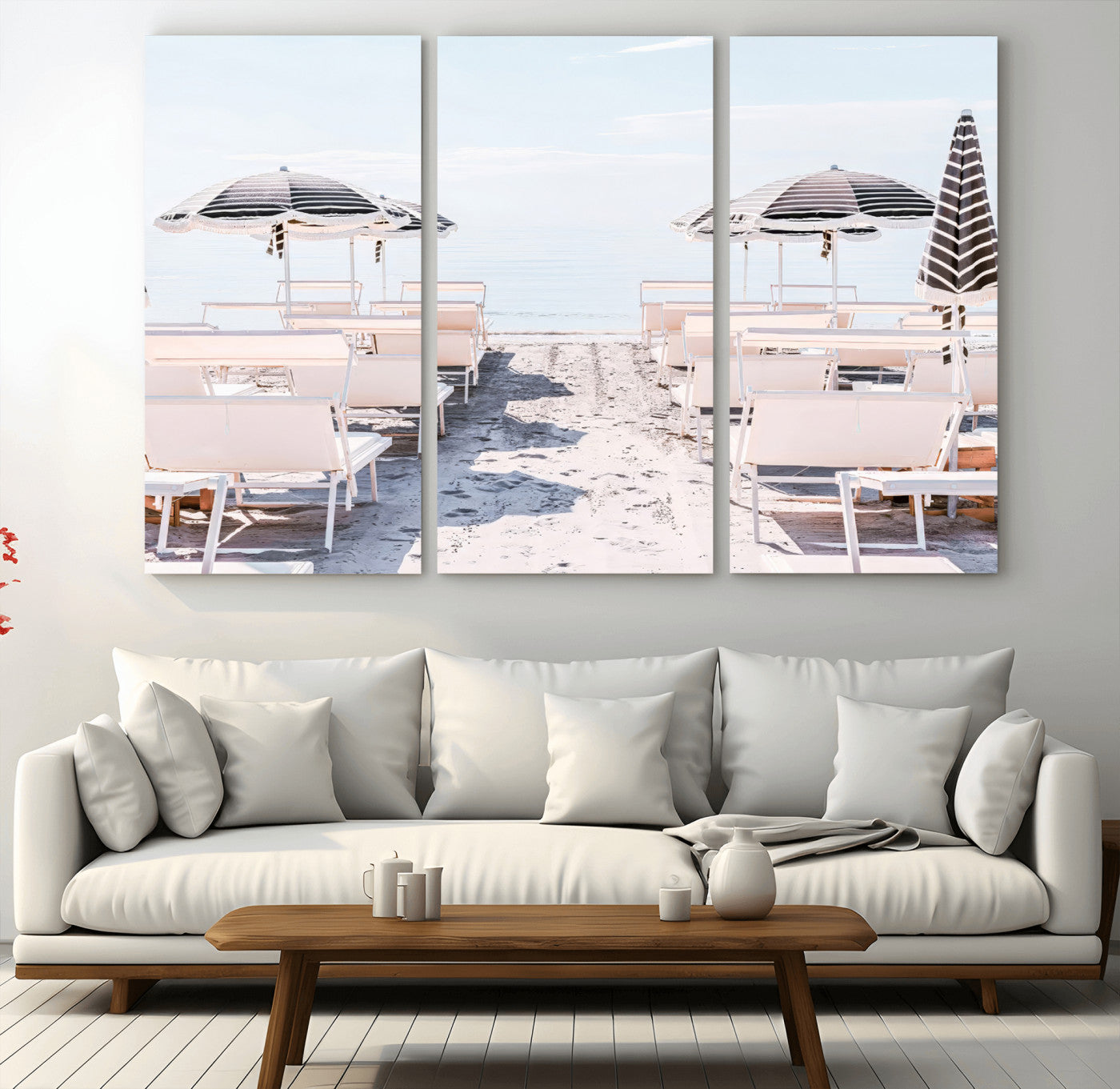 A serene minimalist beach scene featuring striped umbrellas, soft pastel sand, and an elegant lounge setup, creating a tranquil and stylish coastal retreat.