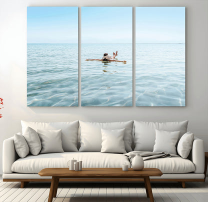 A peaceful minimalist scene of a person floating on crystal-clear water, surrounded by a vast open horizon, capturing relaxation and serenity in a tranquil aquatic setting.