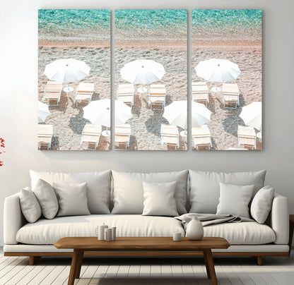 A bright beach scene with white umbrellas, pastel sand, and turquoise waters, creating a tranquil coastal vibe, perfect for beach house or summer decor.