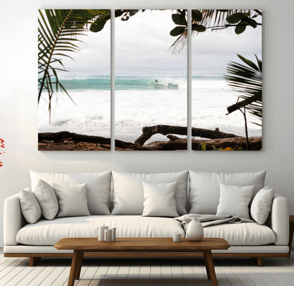 Tropical beach view with palm trees and surfer riding a wave, perfect for boho or coastal-inspired interior wall decor.