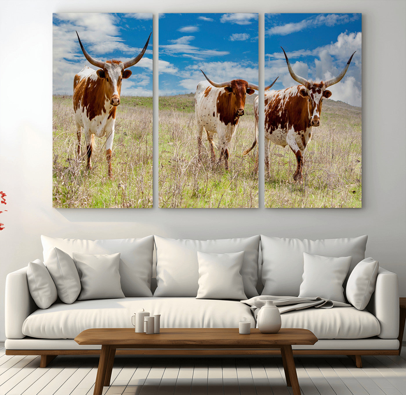 Three Texas longhorn cattle standing in dry grass under a bright blue sky, ideal for farmhouse or western rustic home decor.