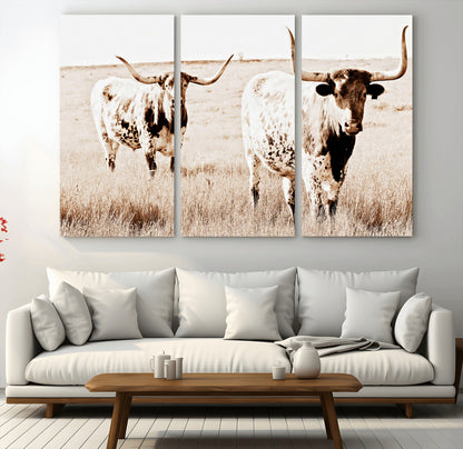 Two Texas longhorn cows standing in a sepia-toned pasture, evoking rustic charm perfect for farmhouse or western country interiors. (