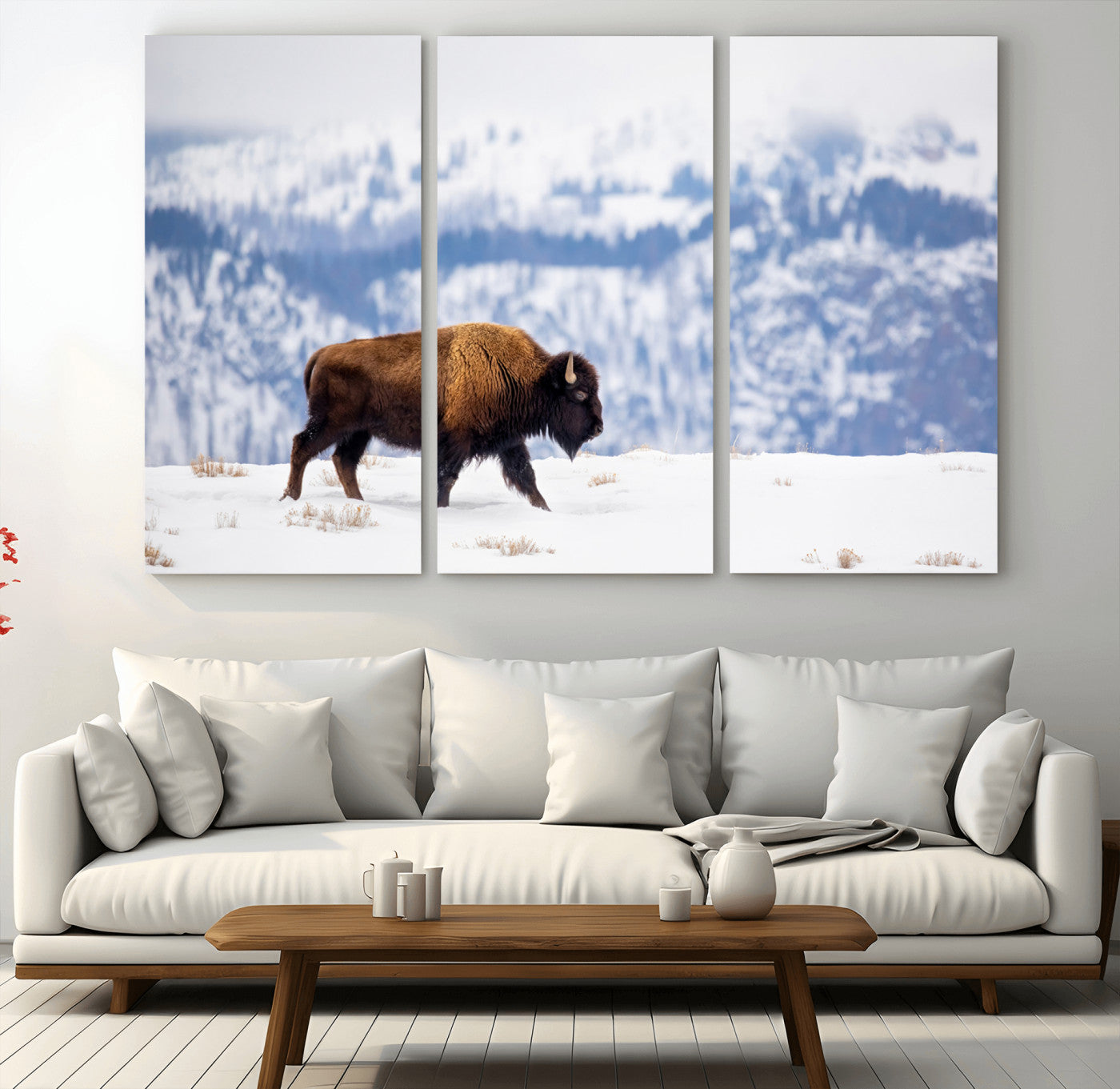 A lone bison walks across snowy ground with blue-toned mountain range behind, ideal for rustic or western farmhouse interiors.