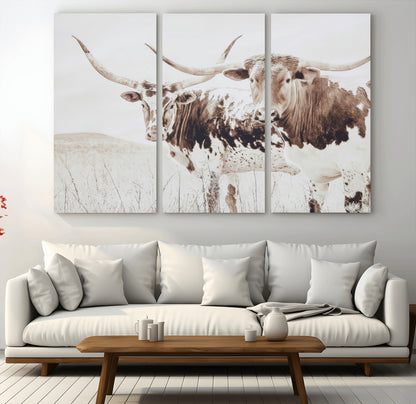 Two longhorn cows standing in a sepia-toned pasture with soft light, ideal for rustic or farmhouse-themed neutral wall decor.