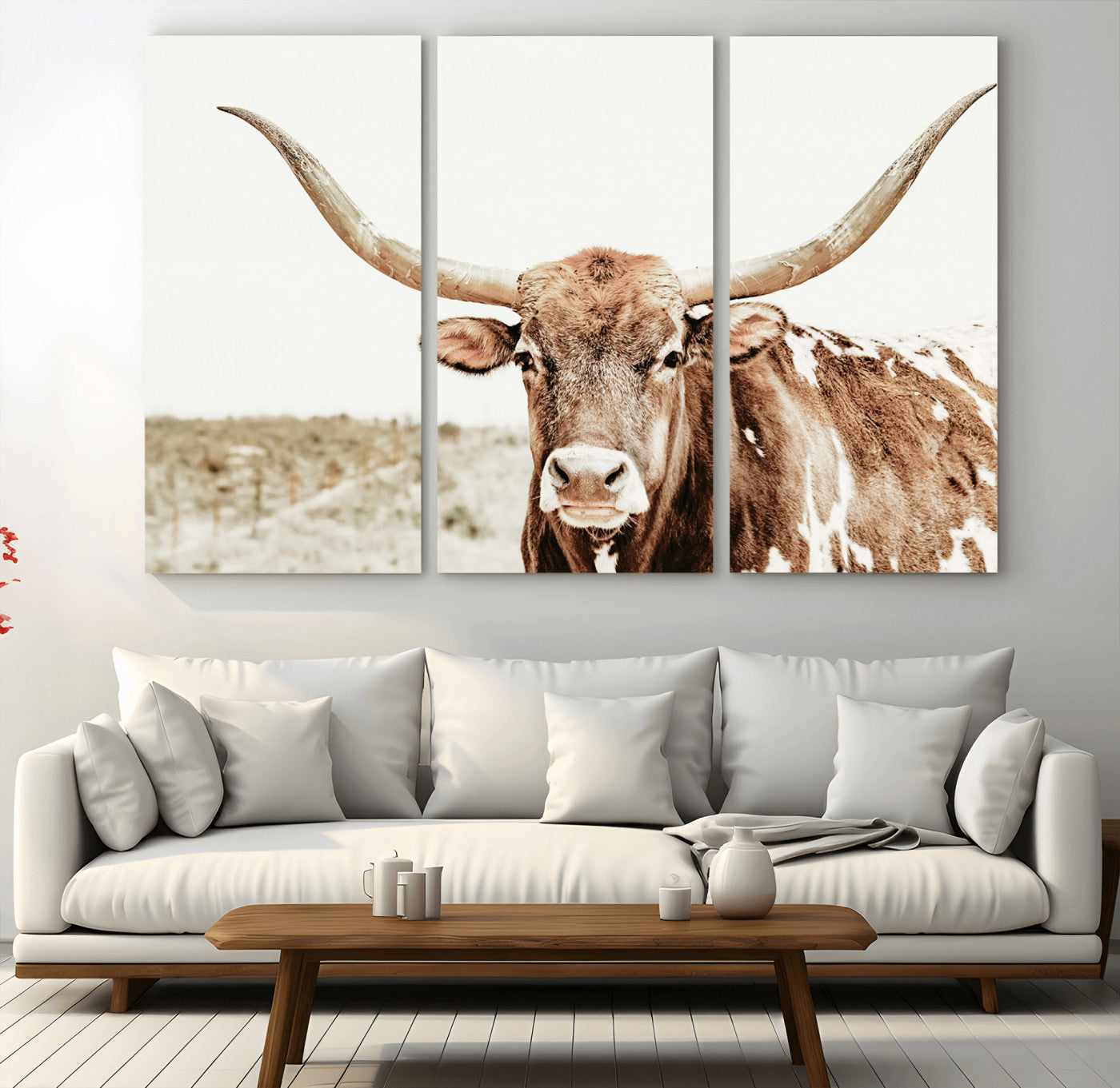 A Texas longhorn bull with wide horns, standing in a dry field under soft light, ideal for rustic farmhouse or western-themed interiors.