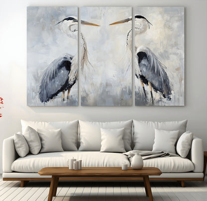 Two herons facing each other on a soft-toned background with blue-grey feathers, perfect for tranquil, coastal or nature-themed interiors.