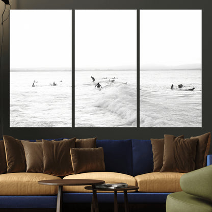 Monochrome photo of surfers riding and waiting on ocean waves, ideal for surf-themed or coastal energy wall decor.