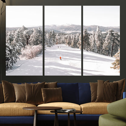 Bright ski trail lined with snow-covered pines and a skier in orange, perfect for alpine adventure or winter sports-inspired decor.