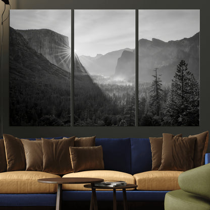 Black and white landscape of Yosemite with sun rays peeking over El Capitan, ideal for moody nature or modern rustic decor.