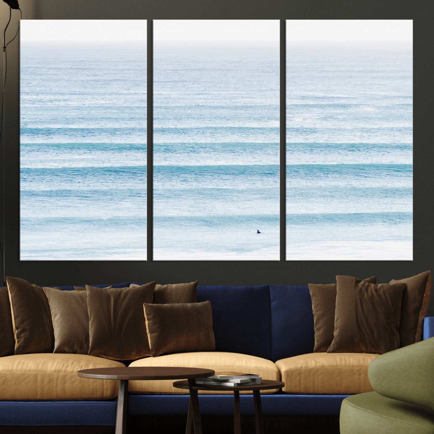 Minimalist ocean view with soft blue waves and a lone surfer, creating a serene and airy coastal aesthetic, perfect for tranquil home decor.