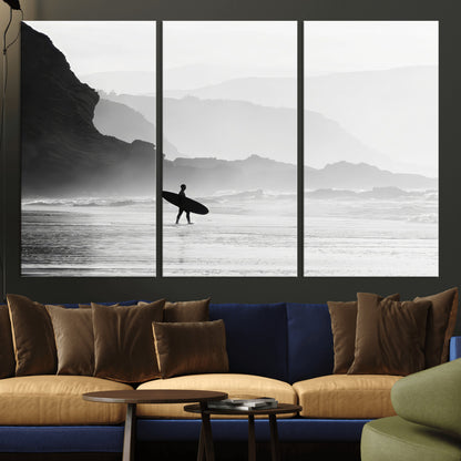 A lone surfer walking along a misty beach with cliffs in the background, carrying their board, capturing a serene and minimal ocean moment.