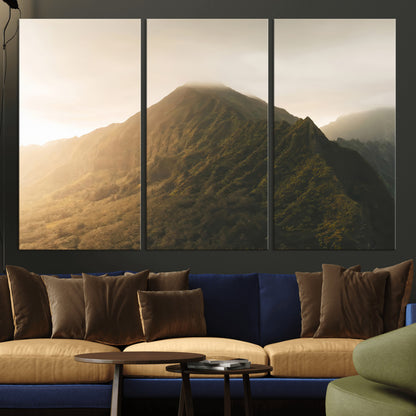 Sunlit mountain peak with mist rolling over its rugged slopes, bathed in golden light, creating a warm and tranquil nature-inspired scene.
