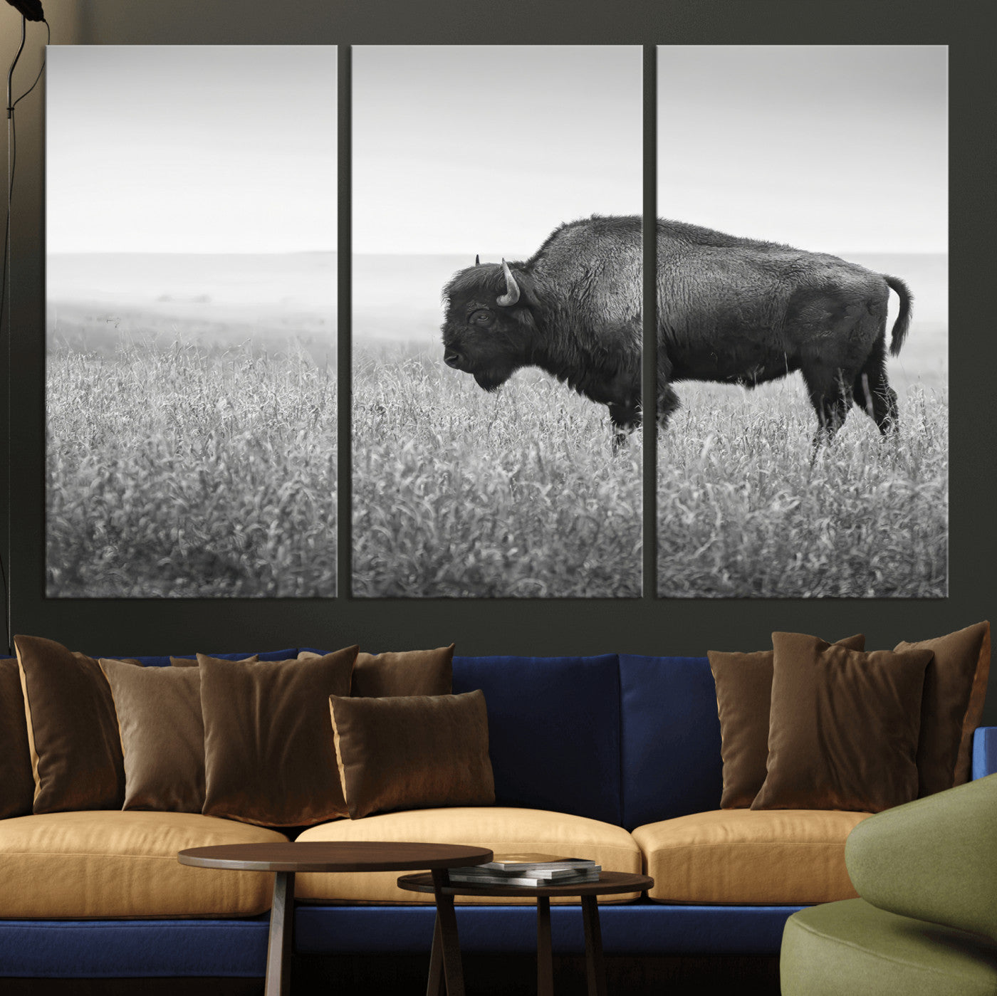 A black and white photograph of a majestic bison standing in a vast grassy prairie, evoking a sense of wilderness and strength.