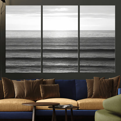 Minimalist black and white ocean view with layered waves reflecting sunlight, evoking a sense of calm and coastal serenity.