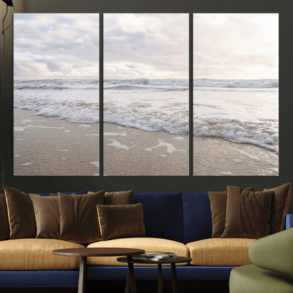 Peaceful ocean waves rolling onto the sandy shore under soft light, perfect for neutral or coastal minimalist decor themes.