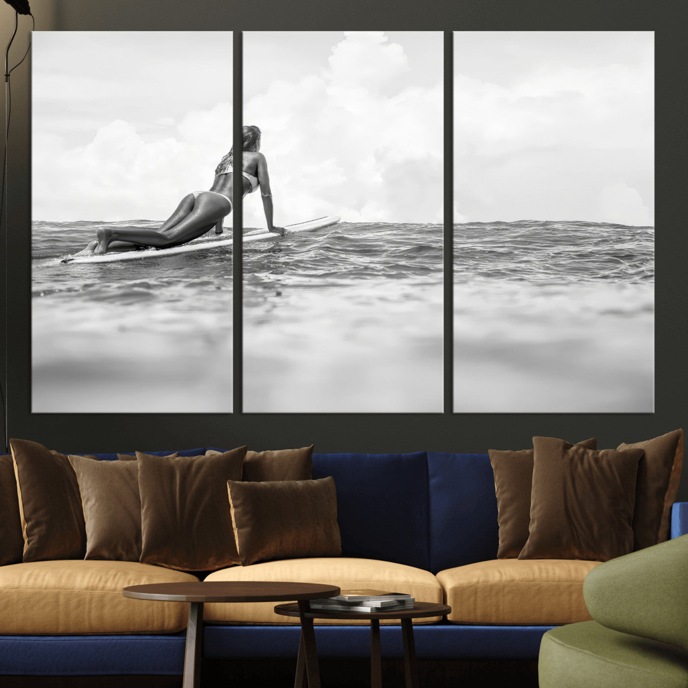 A black and white ocean scene featuring a surfer girl waiting on her board, gazing at the horizon, capturing a tranquil and adventurous coastal moment.