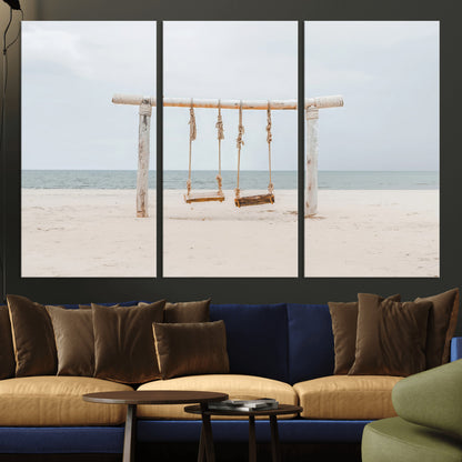 A rustic wooden beach swing stands on a serene sandy shore with an ocean horizon in the background, creating a tranquil and dreamy coastal escape.