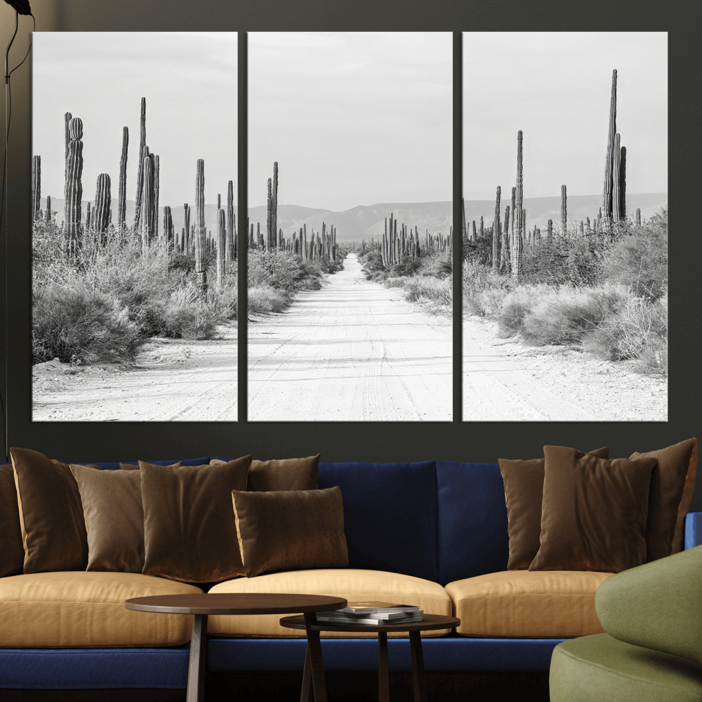 A black and white desert road stretching through a cactus-filled landscape, creating a rugged and timeless southwestern aesthetic with a sense of adventure.