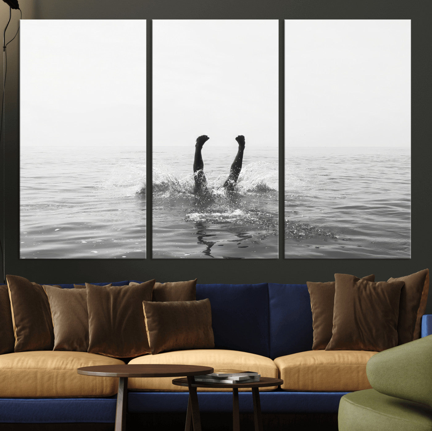 A black and white minimalist water scene capturing a playful splash as a swimmer dives upside down, creating a carefree and artistic aquatic aesthetic.