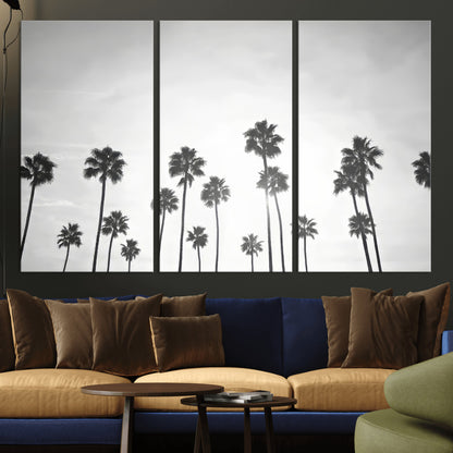 A black and white minimalist scene featuring tall palm trees silhouetted against a bright sky, creating a dreamy and timeless tropical aesthetic.