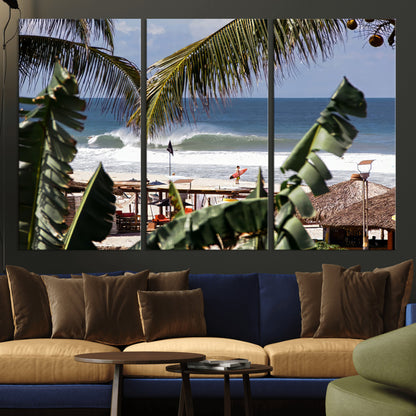 Canvas wall art of a tropical surf scene framed by palm trees, with a surfer on the shore and waves rolling in, ideal for beach-themed decor.