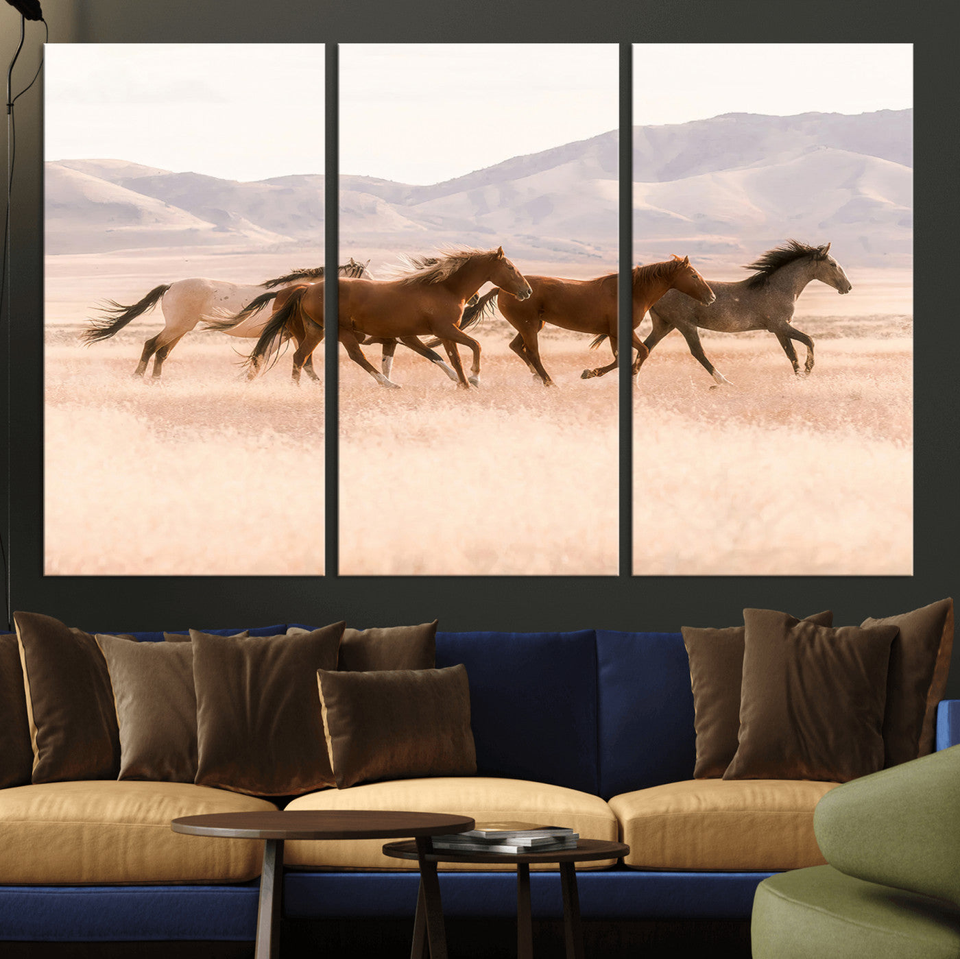 A herd of wild horses galloping through a sunlit desert plain with mountains in the background, perfect for rustic or western-themed wall decor.