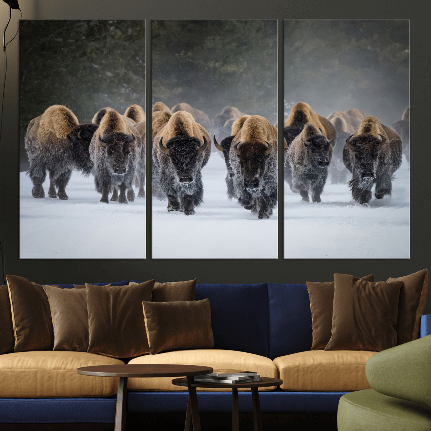 A herd of American bisons walking through deep snow in a forest, evoking a powerful rustic wilderness mood for western-style interiors.