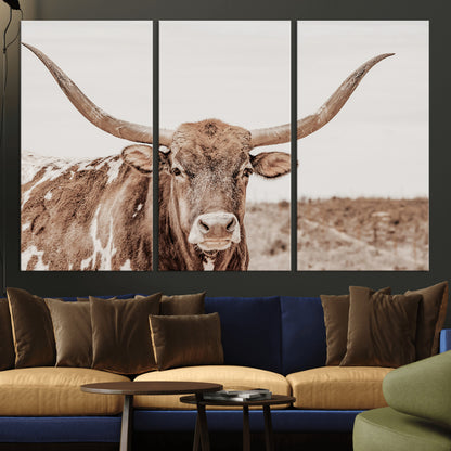 A longhorn cow in soft beige desert tones, standing calmly in open land, perfect for neutral western or rustic farmhouse interiors.