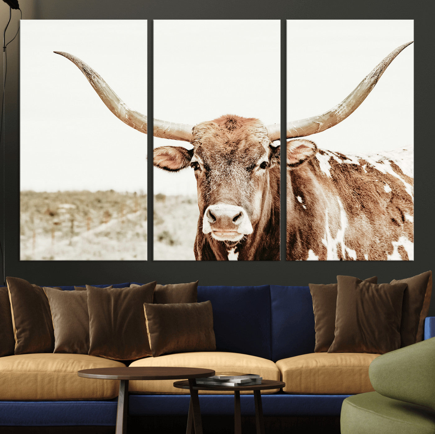 A Texas longhorn bull with wide horns, standing in a dry field under soft light, ideal for rustic farmhouse or western-themed interiors.