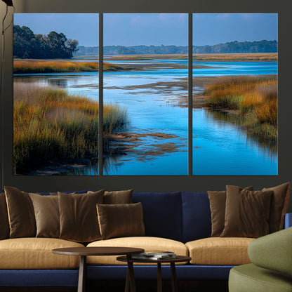 A peaceful marshland scene with calm blue water reflecting the surrounding grasses and trees, capturing the beauty of nature in a serene landscape.