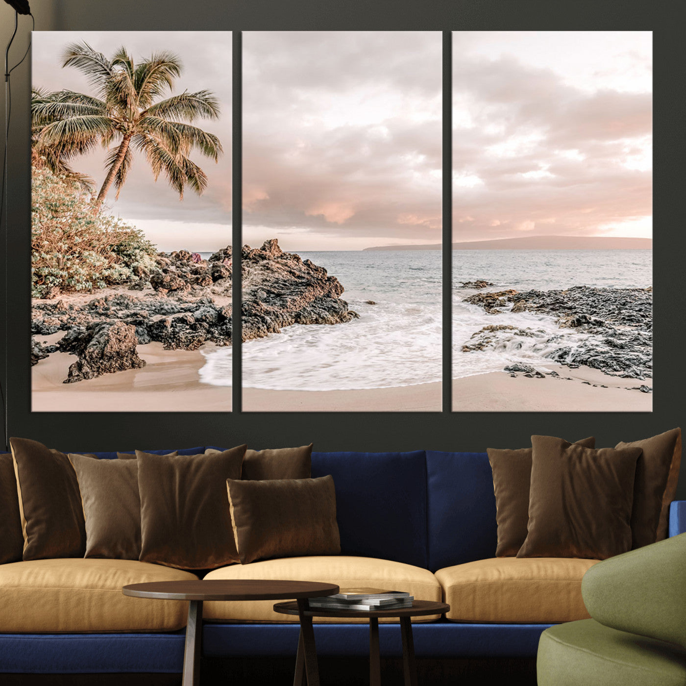A peaceful beach scene with a palm tree and rocks, soft waves washing onto the shore under a soft pastel sky at sunset.