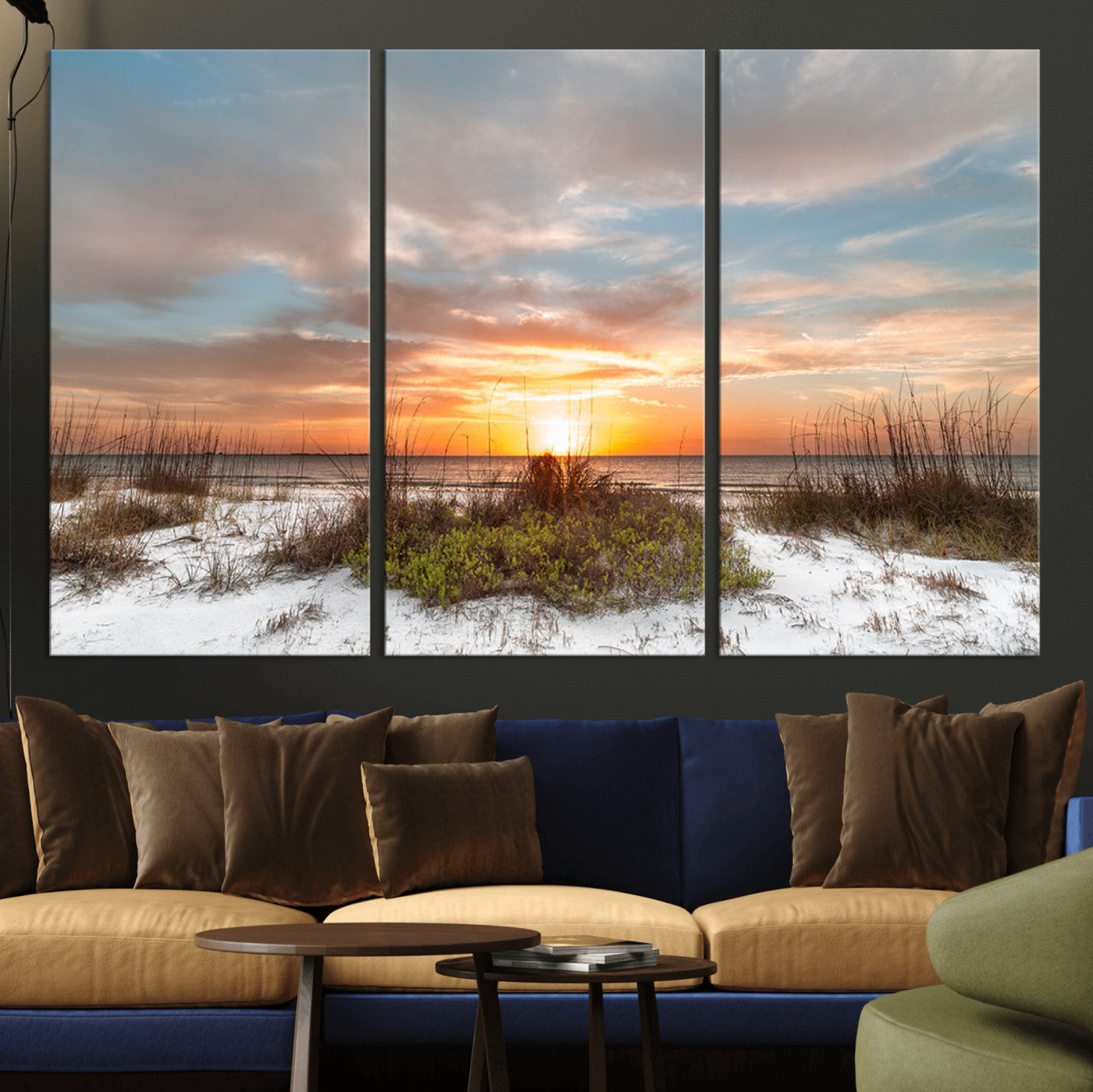 A tranquil beach scene featuring golden sunset hues over the water, with grasses in the foreground and a peaceful, serene atmosphere.