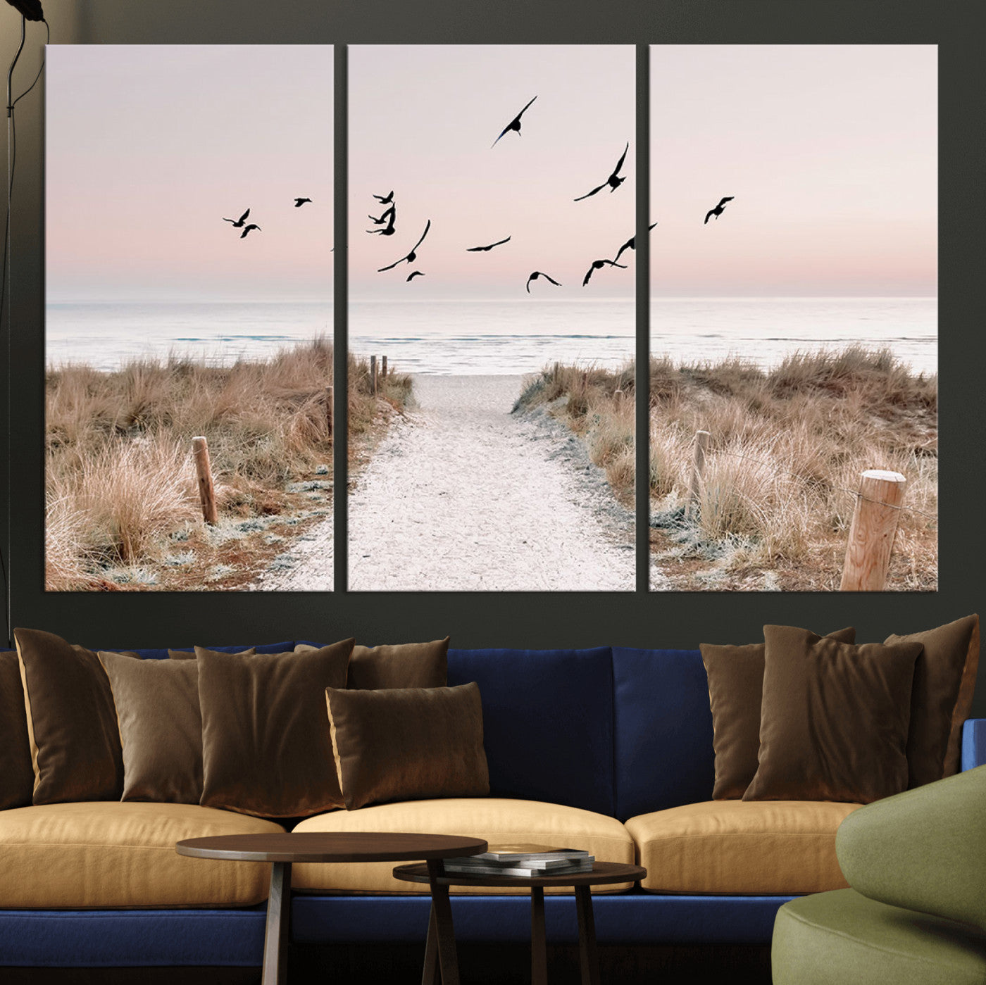 A peaceful coastal pathway leading to the ocean, with birds flying across a soft pastel sky, creating a calm and scenic beach atmosphere.