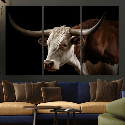 "Close-up of a brown and white longhorn cow with prominent curved horns against a black background."