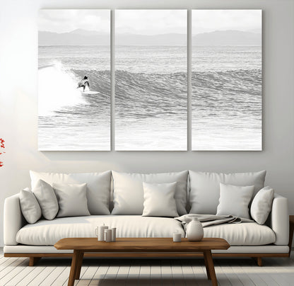 Monochrome photo of a surfer riding a wave with distant mountains, ideal for coastal motion or black and white surf-themed wall decor.