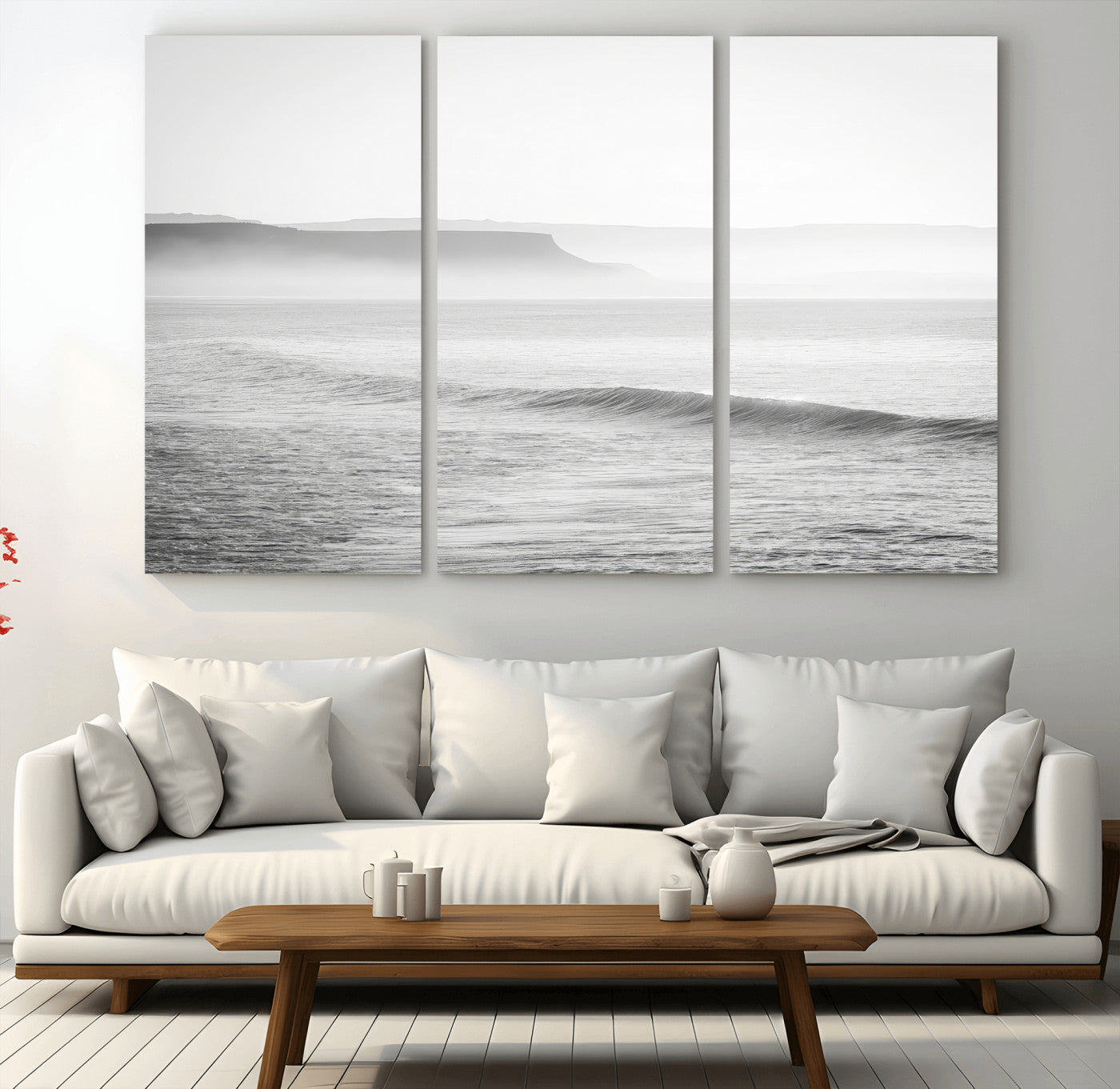 A black and white minimalist seascape featuring soft rolling waves and misty distant cliffs, creating a serene and timeless coastal atmosphere.