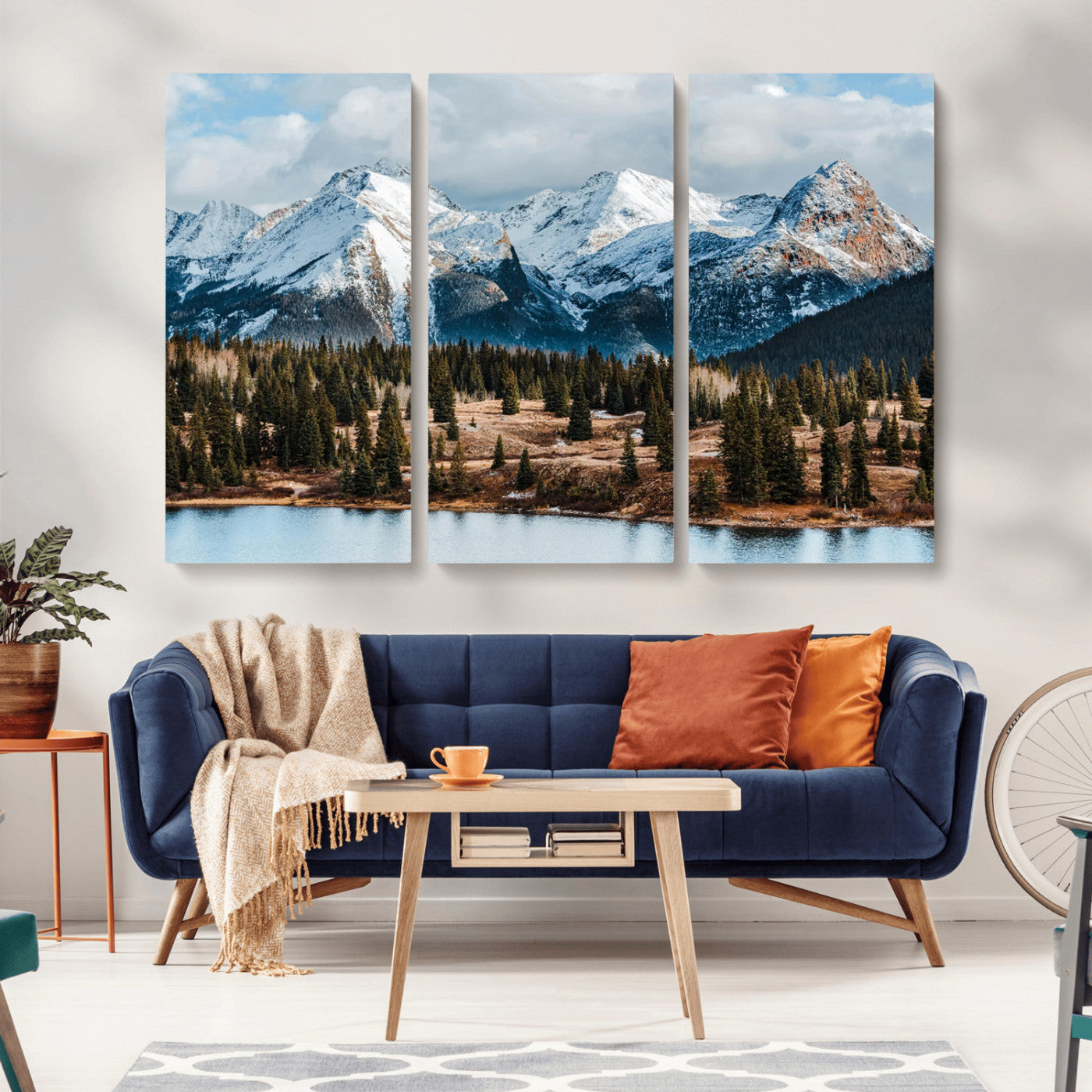 Framed canvas of snowy mountain peaks with pine forest and alpine lake, perfect for winter cabin or wilderness-inspired home decor.