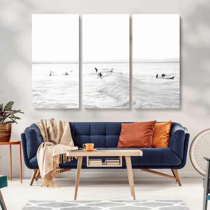 Monochrome photo of surfers riding and waiting on ocean waves, ideal for surf-themed or coastal energy wall decor.