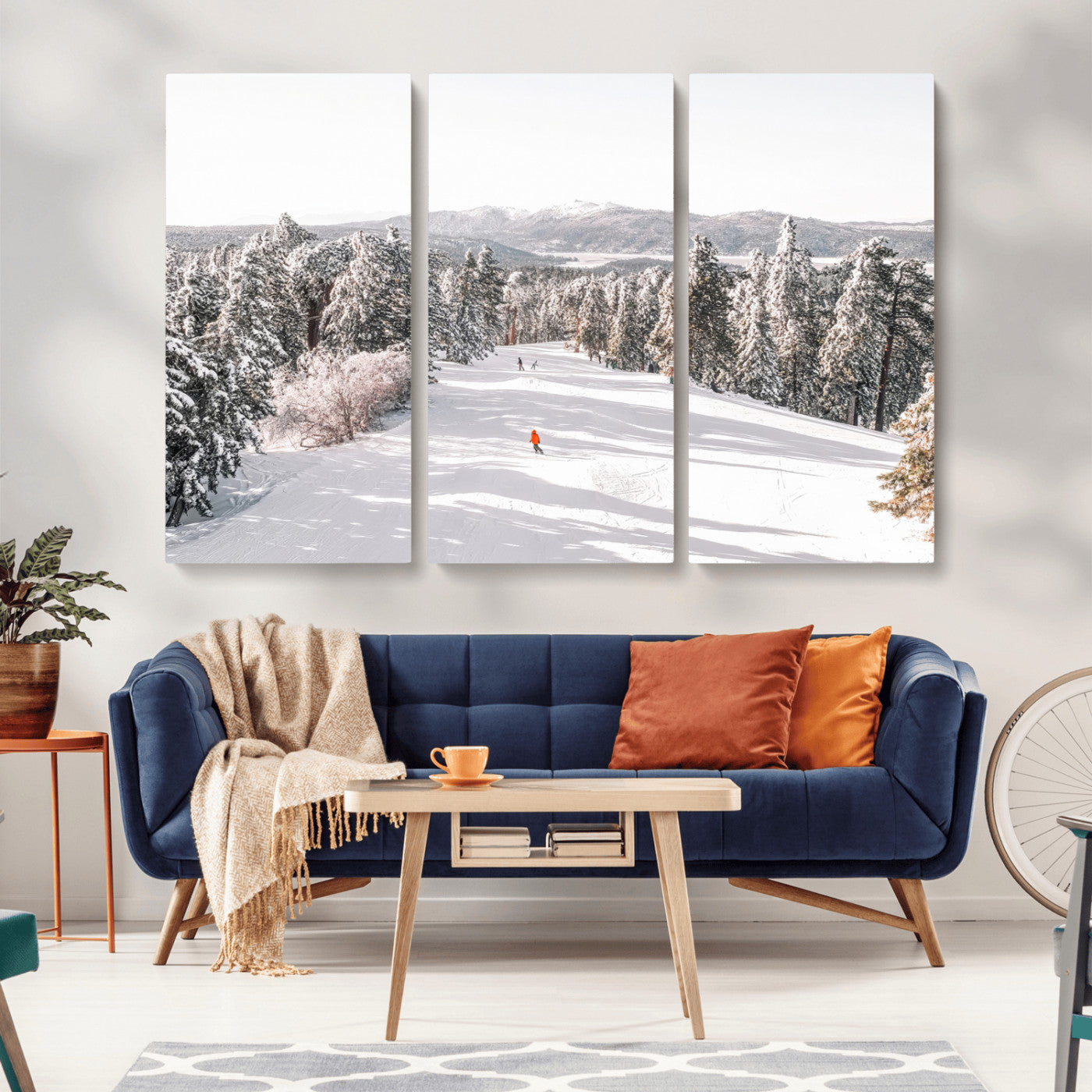 Bright ski trail lined with snow-covered pines and a skier in orange, perfect for alpine adventure or winter sports-inspired decor.