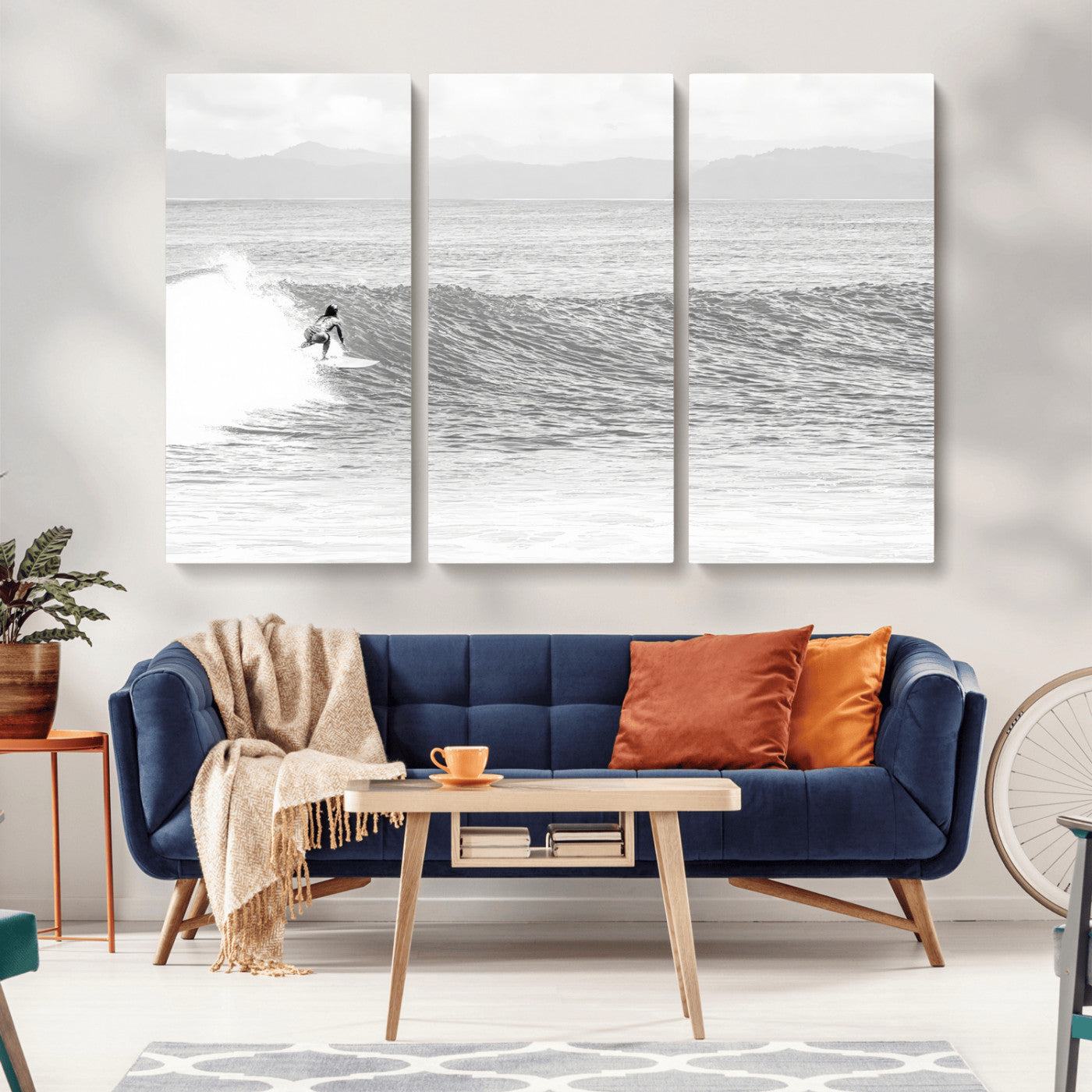 Monochrome photo of a surfer riding a wave with distant mountains, ideal for coastal motion or black and white surf-themed wall decor.
