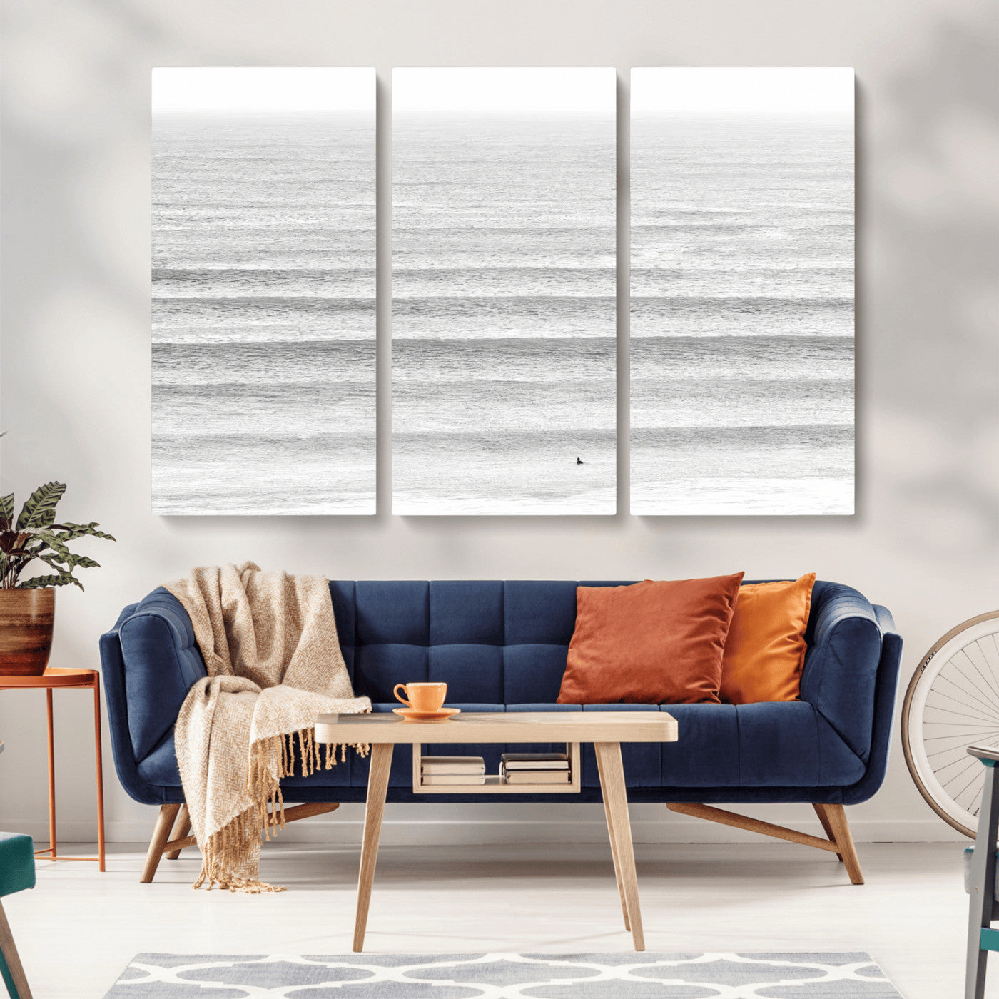 Monochrome photo of a lone surfer in calm layered waves, perfect for minimalist coastal or moody ocean-inspired wall decoration.