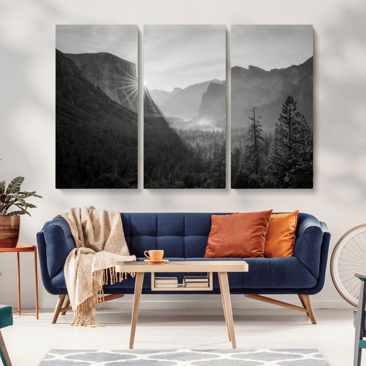 Black and white landscape of Yosemite with sun rays peeking over El Capitan, ideal for moody nature or modern rustic decor.